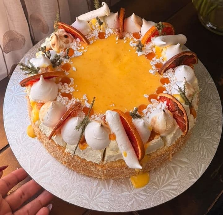 Citrus curd cake crowned with meringues and dried orange